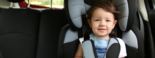kid in backseat of vehicle