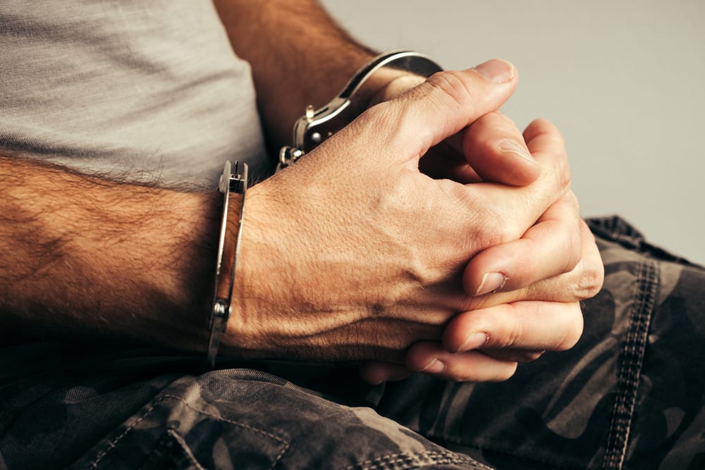 sitting man handcuffed